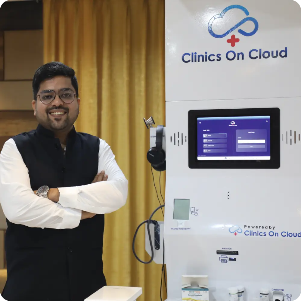 Abhay Agarwal beside a Health ATM under a Clinics On Cloud sign