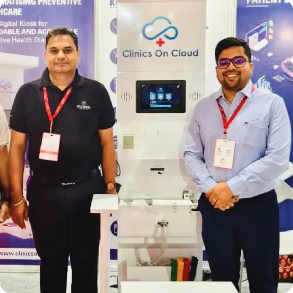 Two men beside a Health ATM at an industry event