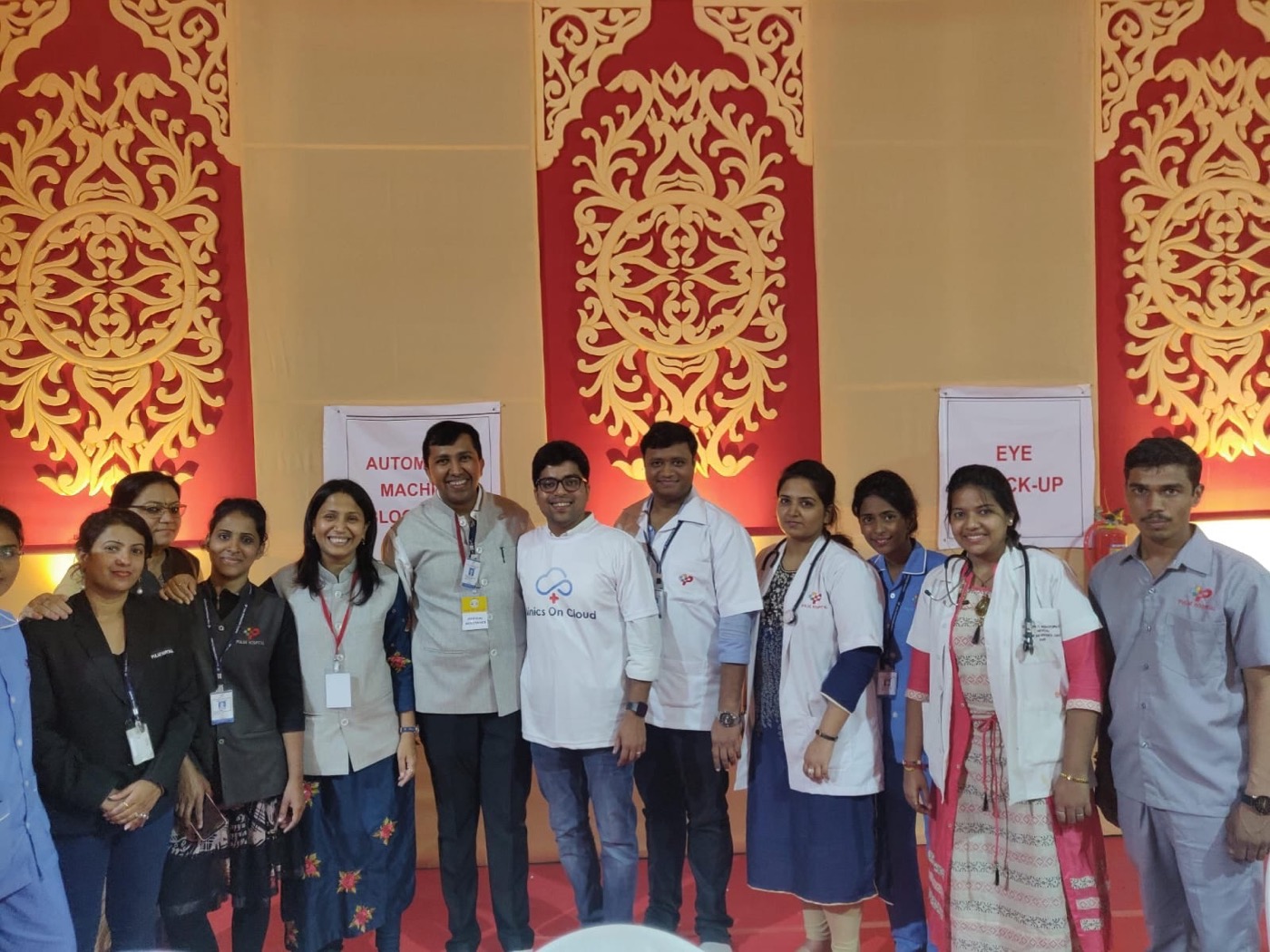 A health camp team in white coats at a decorated venue