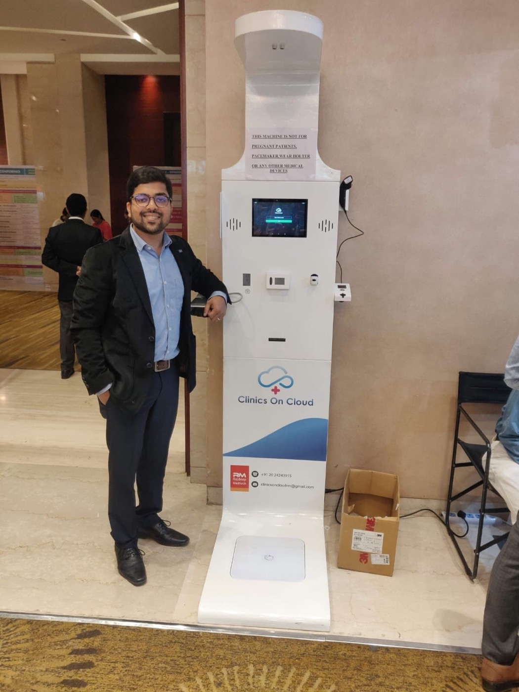 Abhay Agarwal beside a Health ATM on site