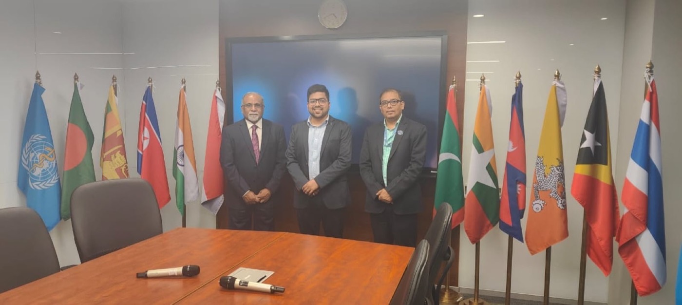 A delegation meeting in a room hung with flags